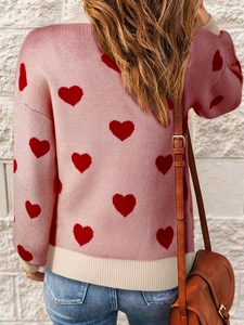 Women's pink knit sweater with red heart jacquard and ribbed trim shown in a back view