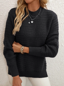 Detail of black long sleeve knit sweater with wavy texture and ribbed cuffs for women