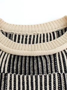 Women's crewneck knit sweater with beige and black vertical stripes and ribbed neckline