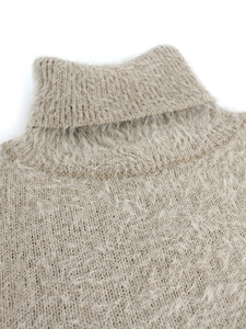 Close-up of soft turtleneck collar on light khaki knitted sweater with plush texture
