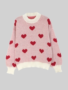 Pink crewneck knit sweater with red heart patterns and white ribbed cuffs and hem