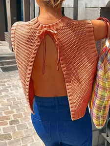 Close-up of knit tank top with backless V-cut design and ribbon tie closure