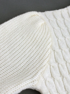 White cable knit crewneck sweater dress featuring detailed shoulder stitching and texture