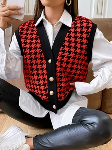 Dettaglio gilet in maglia pied-de-poule rosso con bottoni dorati vintage e scollo a V