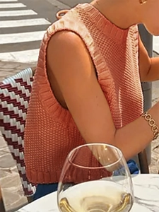 Detail of peach pink knitted tank top with thick texture and ribbed mock neck finish
