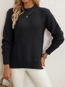 Detail of dark grey knit sweater with wave texture and ribbed cuffs on model