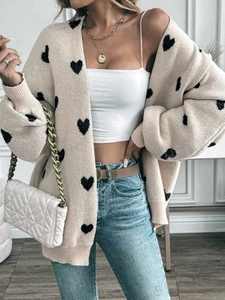Dettaglio del cardigan in maglia da donna con cuori neri e polsini a coste