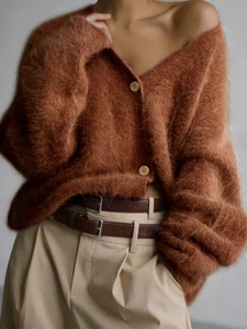 Close-up of caramel knit cardigan featuring a fuzzy texture and vintage button detail