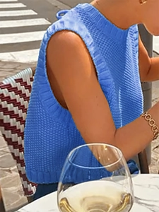 Close-up of bright blue knit tank top showing ribbed texture and classic round neck