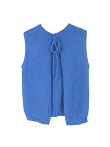 Detailed macro view of royal blue knitted vest with open back design and neck tie detail
