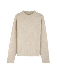 Detailed close-up of oatmeal knit sweater showing ribbed crewneck and soft wool texture