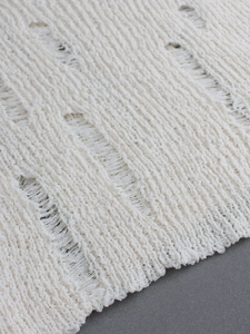 Women's white long sleeve knitted sweater with stylish distressed ripped details