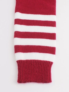Detail of red and white striped knit texture with ribbed cuffs for a cozy winter look