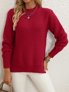 Detail of red crewneck sweater featuring unique wavy knit texture and ribbed cuffs