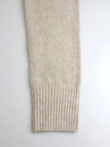 Elegant beige knitted long sleeve sweater for women featuring ribbed cuffs and soft wool texture