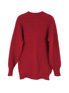 Close-up of dark red wave-textured knit sweater with ribbed cuffs and round neckline
