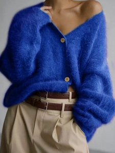 Detailed close-up of blue V-neck knit cardigan with rich fuzzy texture and brown buttons