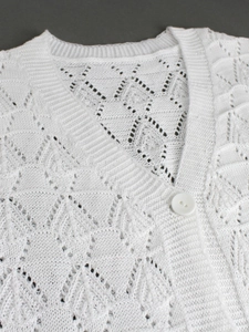 White knit V-neck short sleeve cardigan featuring hollow crochet geometric patterns