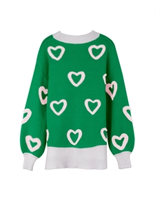Close-up of women's green knit sweater with pink hearts and white ribbed collar and cuffs
