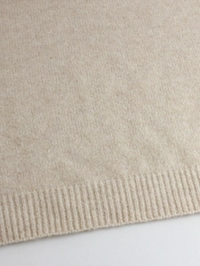 Elegant beige knitted long sleeve crewneck sweater with premium ribbed cuffs