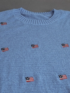 Light blue crew neck sweater with American flag embroidery patches in soft knit fabric