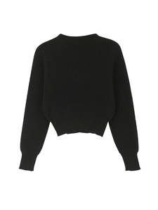 Detail of black crewneck knit sweater showing ribbed cuffs and textured knit fabric