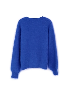 Close-up of vibrant blue mohair knit cardigan showing soft texture and ribbed cuffs
