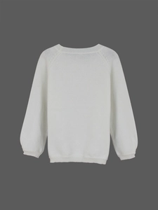Close-up of ribbed cuffs and hem on a white long-sleeve knit sweater with crew neck