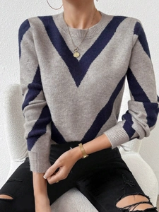 Women's light grey crewneck knit sweater featuring navy blue chevron patterns and ribbed cuffs