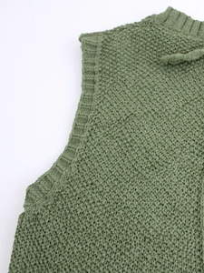 Detail of the army green knit vest showing ribbed neckline and armhole texture