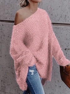 Close-up of pink oversized off-shoulder knit sweater with fluffy faux mink fur texture