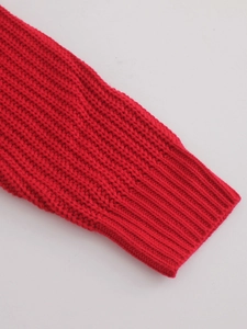 Red knit sweater featuring thick ribbed cuffs and high-quality textured finish