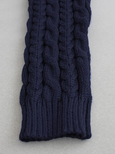 Women's dark blue cable knit leg warmers with ribbed cuffs and thick wool texture