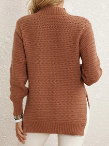 Detail view of brown knit sweater featuring stylish side slits and wavy textured fabric