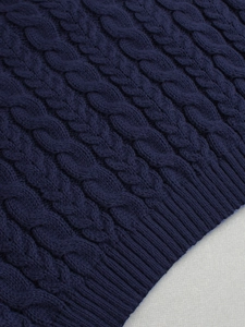 Women's dark blue cable knit turtleneck sweater with ribbed hem detail