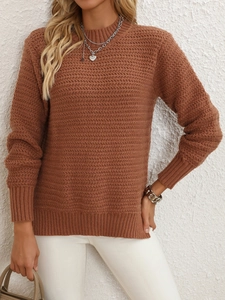 Detail shot of rust red knit sweater featuring wavy texture and ribbed crew neckline