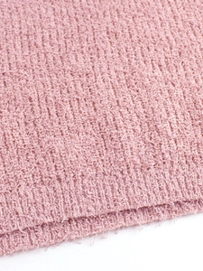 Close-up of pink ribbed knit sweater featuring soft fuzzy texture and premium fiber detail