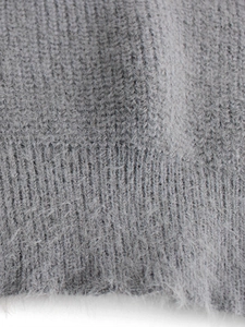 Close-up of grey knit sweater fabric showing soft fuzzy mohair texture and ribbing