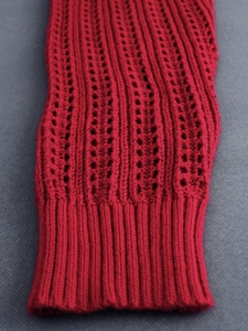 Women's V-neck red long sleeve knit sweater with hollow-out pattern and ribbed cuff detail
