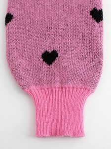 Pink rib knit sweater with black heart jacquard pattern and snug ribbed cuff details