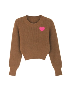 Close-up of brown knit sweater with a pink heart embroidery and ribbed cuffs detail