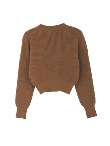 Detailed close-up of brown knit sweater texture with vertical stripes and ribbed cuffs