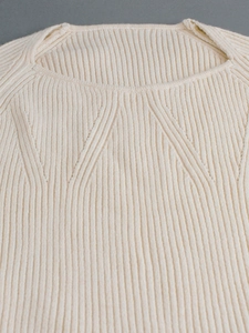 Close-up of off-white rib-knit square neck long sleeve sweater with raglan seams