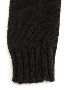 Detailed macro view of the black ribbed cuffs on a long-sleeve knit sweater for women