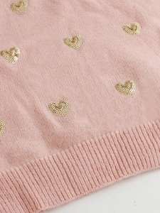 Gilet tricoté rose sans manches avec motifs cœurs en paillettes dorées et bord côtelé