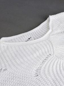 Women's white long sleeve knit sweater with intricate pointelle pattern and neckline detail