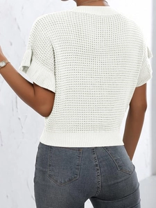 Detail of white waffle knit texture and ruffle sleeve on a short sleeve sweater