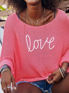 Detail of coral pink hollow-out knit sweater with white love script embroidery