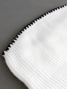 White knit vest with contrast black scalloped edges for casual summer resort style