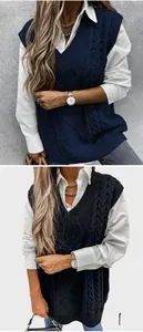 Macro shot of V-neck cable knit vest showing detailed texture and side split hem
